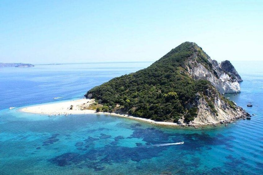 A tropical island with a white sandy beach, clear blue waters, and lush green vegetation. 3