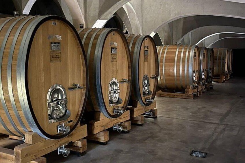 Wooden wine barrels in a warehouse. 1
