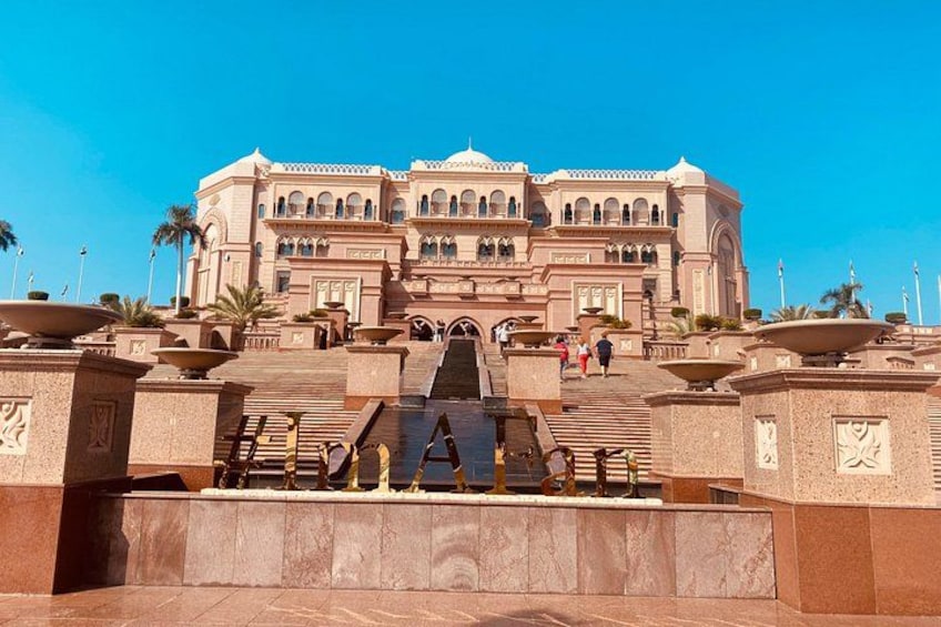 A grand building with multiple arches and a central fountain. 3