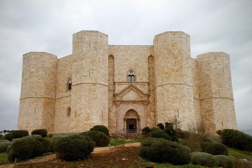A large stone castle with four towers and a central entrance. 4