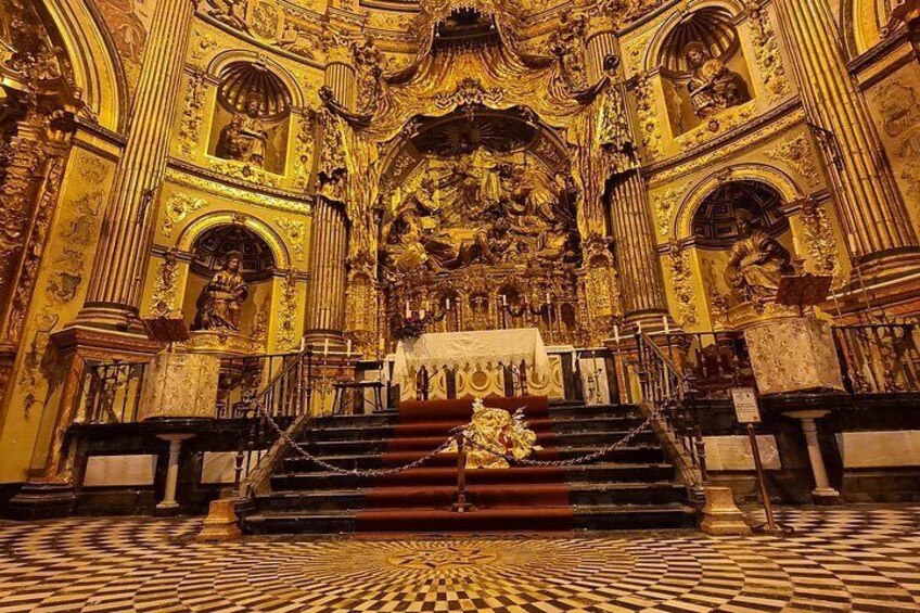 An ornate church interior with a central altar, steps leading up to it, and intricate gold detailing. 2