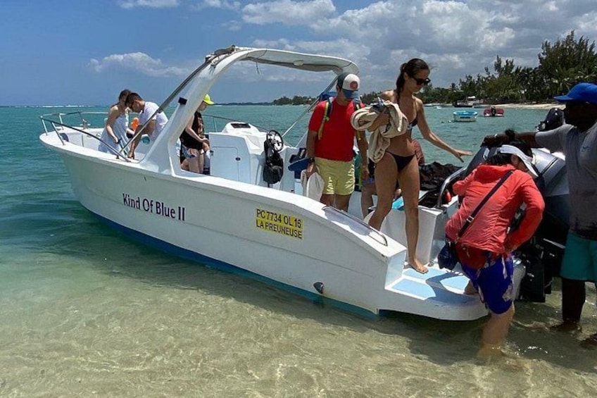 A boat named 'Kind Of Blue II' with people boarding and disembarking. 1