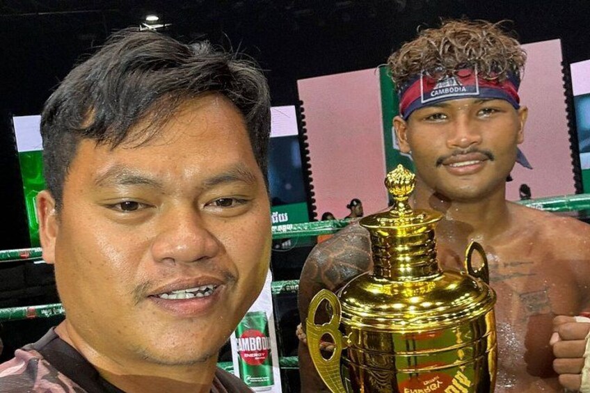 A person holding a trophy. 2