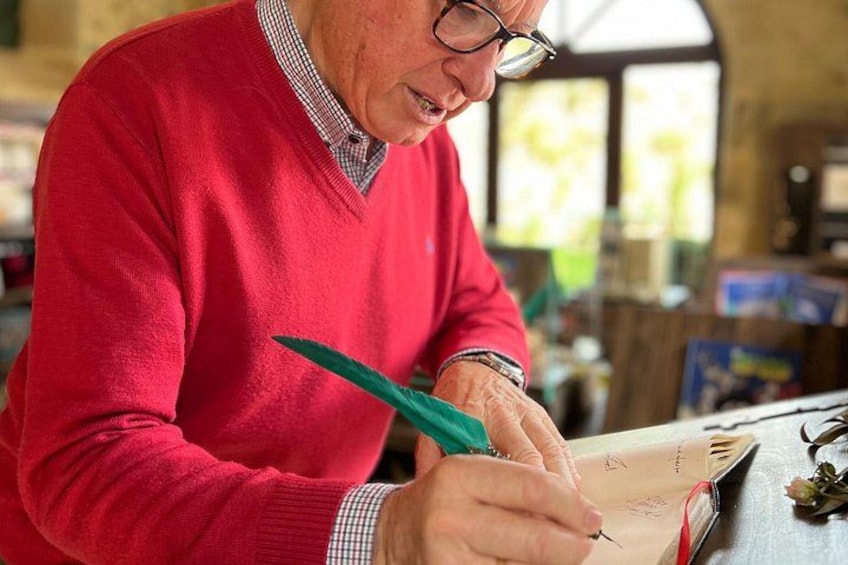 A person in a red sweater writing on a piece of paper. 2