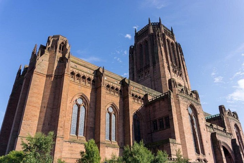 A large brick cathedral with tall towers and arched windows. 3