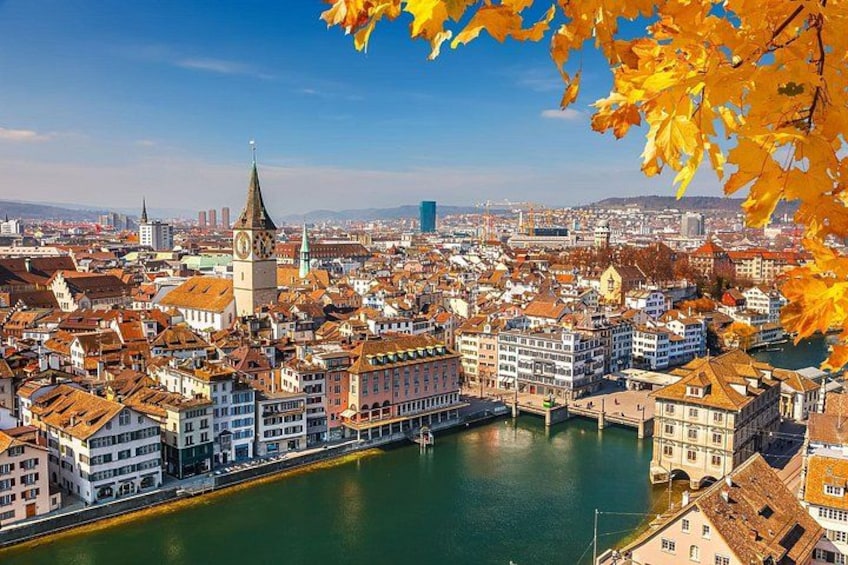 A cityscape with a river, historic buildings, and a prominent tower. 2