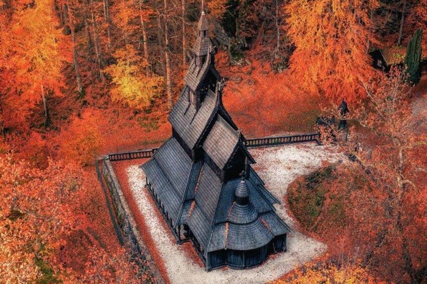 A traditional Japanese temple surrounded by autumn foliage. 4