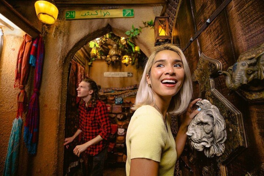 A narrow passageway with a lion head decoration, a person in a red plaid shirt, and a sign indicating the number 24. 4