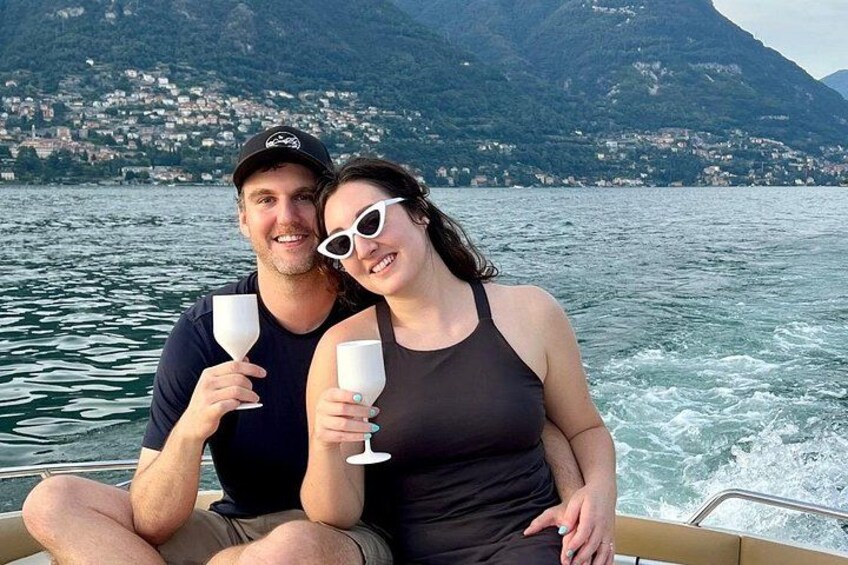 A couple on a boat with a mountainous landscape in the background. 5
