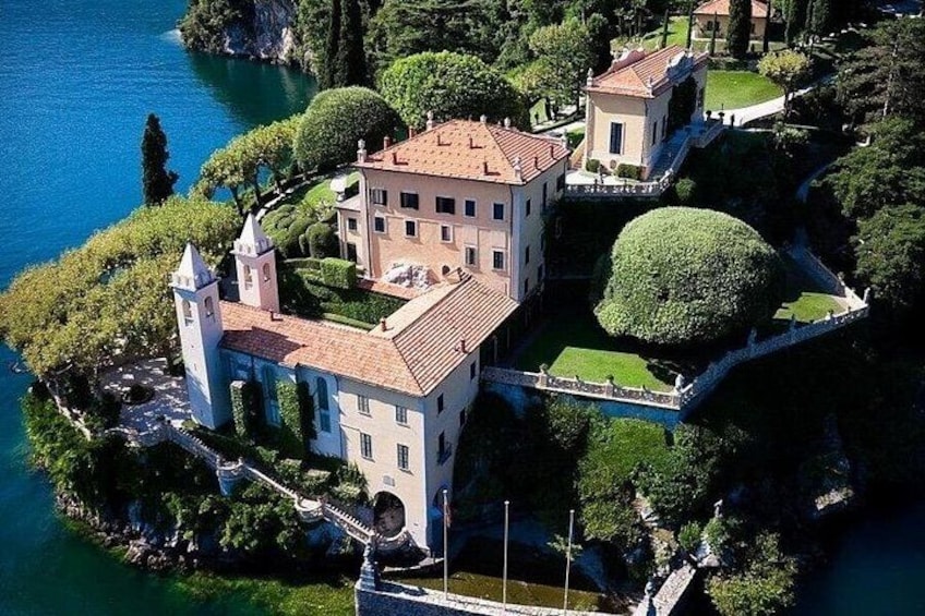 A large estate with a central building, a tower, and a lake. 2