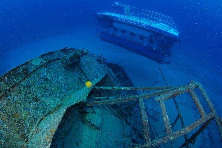 A submerged shipwreck with a diver and a submersible nearby. 5