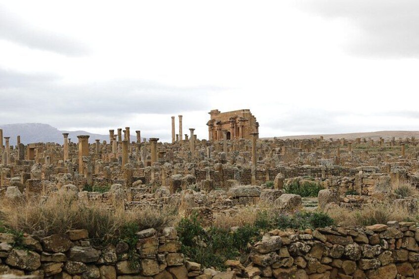Ancient ruins with columns and stone structures. 4