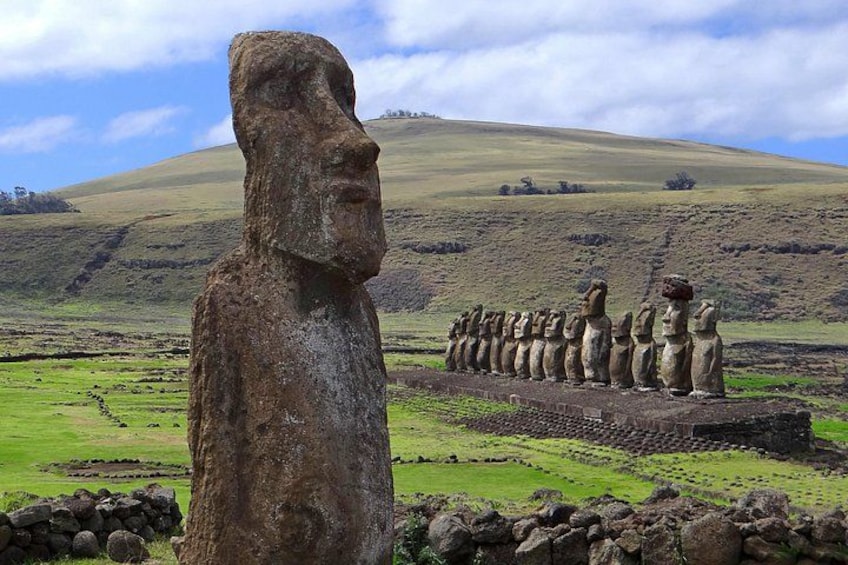 A large stone statue in the foreground and a row of similar statues in the background. 2