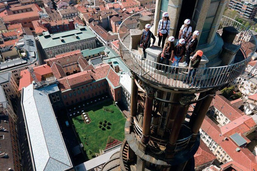 A group of people on a high observation deck with a cityscape below. 1