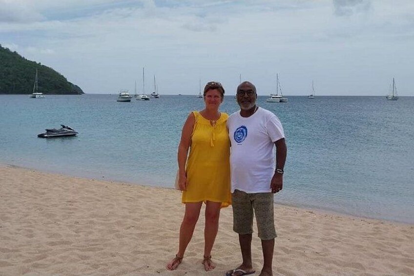 A beach with a sandy shore, a woman in a yellow dress, and a man in a white t-shirt. 4