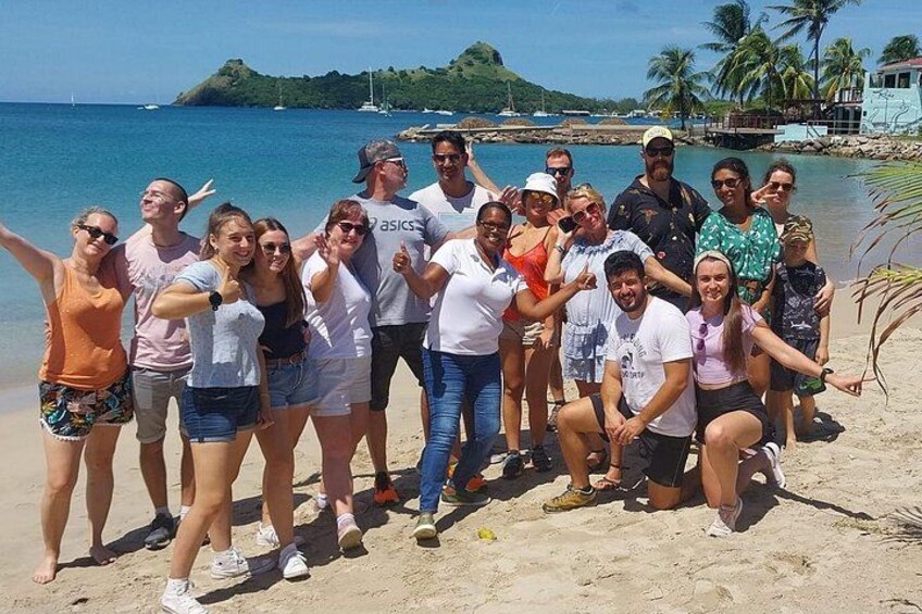 A group of people on a beach with palm trees and a clear sky. 5