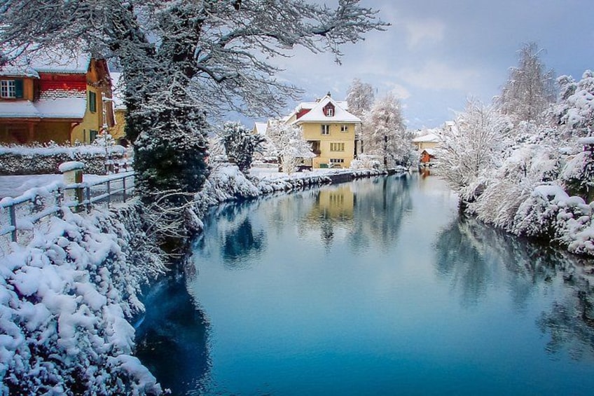 A snow-covered river with buildings on the banks. 2