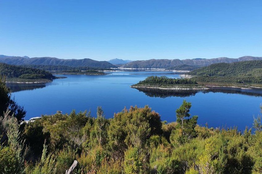 A lake surrounded by mountains and dense forest. 3