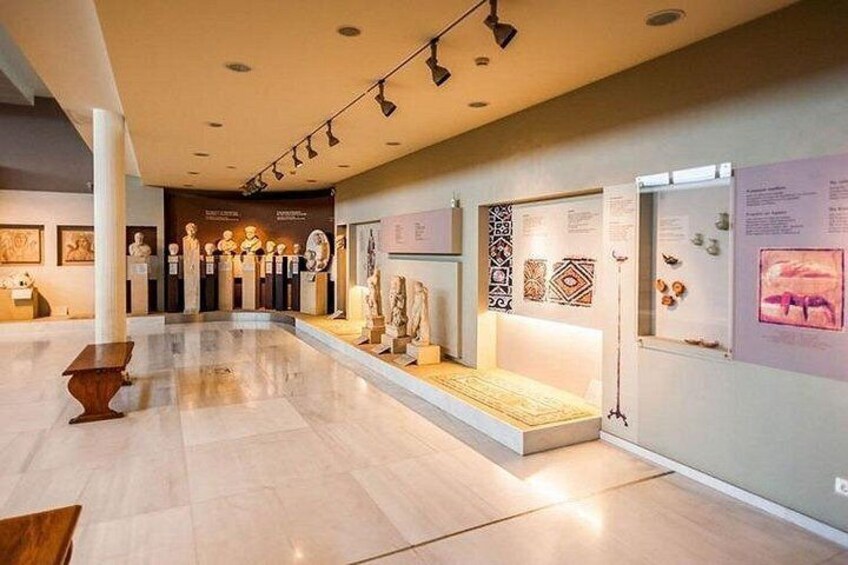 A museum interior with marble floors, display cases, and informational plaques. 4