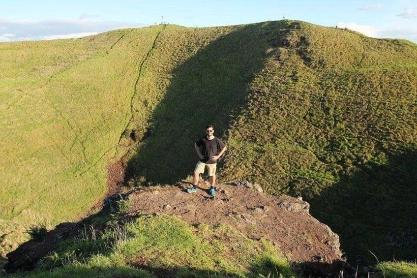 A person standing on a hilltop with a vast landscape in the background. 2