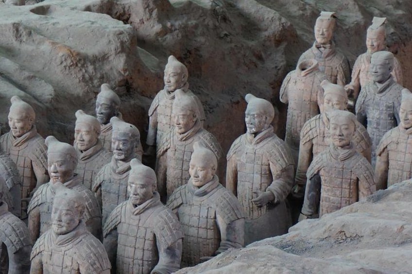 Terracotta soldiers in a row, standing in a formation. 1