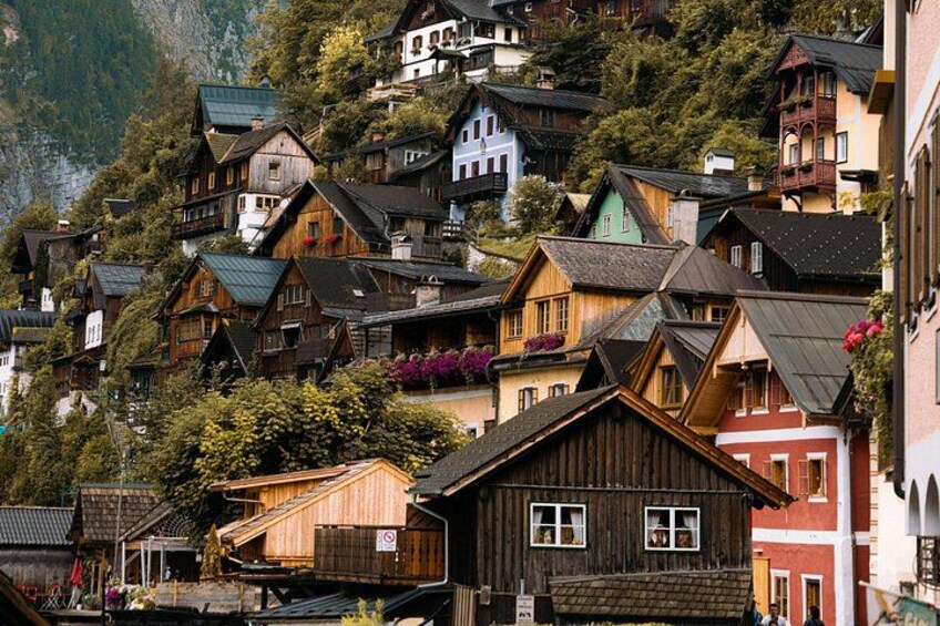 A hillside village with wooden houses and a mountain backdrop. 4
