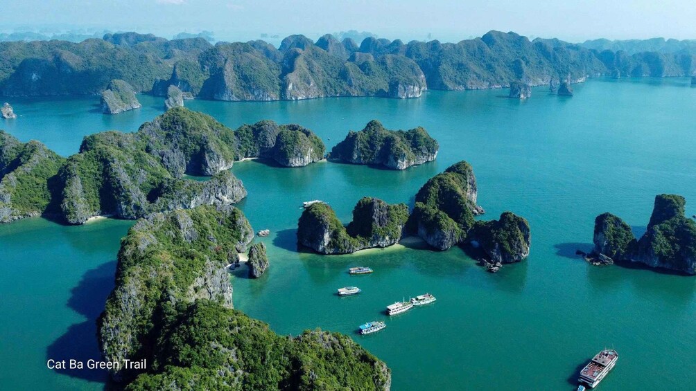 A coastal landscape with numerous limestone islands surrounded by turquoise waters. 4