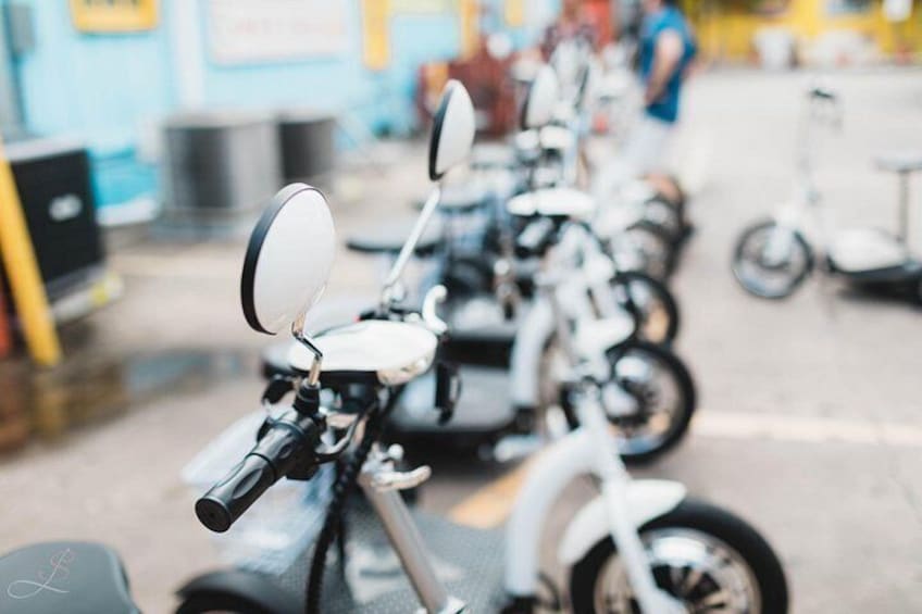 A row of motorcycles parked in an indoor setting. 3