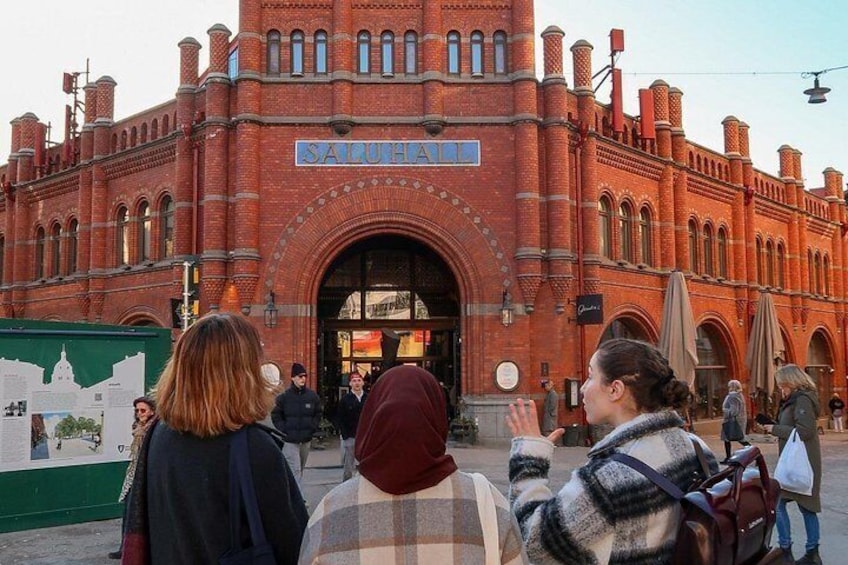 A historic red brick building with arched windows and a sign reading 'SAURHAUS.' 3