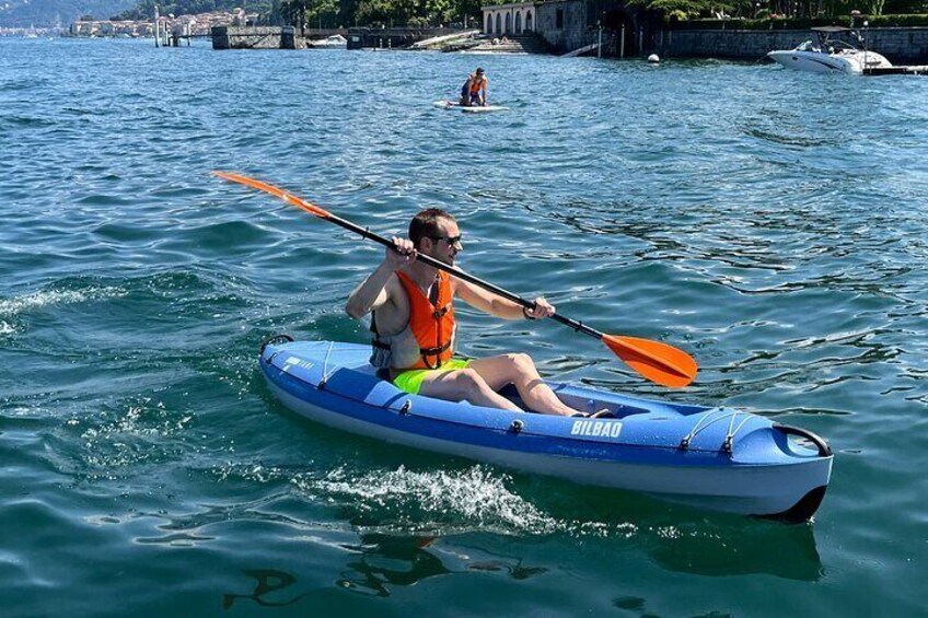 A person kayaking on a blue inflatable raft with a paddle. 3