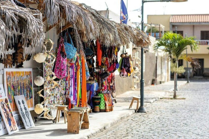 A street market with colorful bags and handicrafts. 2