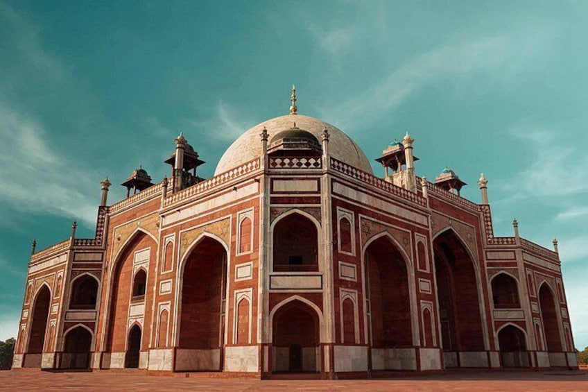 A large, historic building with a central dome and multiple arches. 4