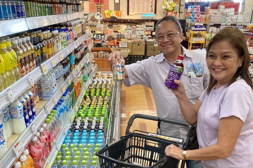 A grocery store aisle with various beverages and a shopping cart. 2