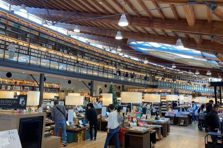 Una libreria a più livelli con travi in legno ed scaffali colmi di libri. 3
