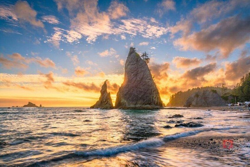 A coastal landscape with two prominent rock formations during sunset. 4