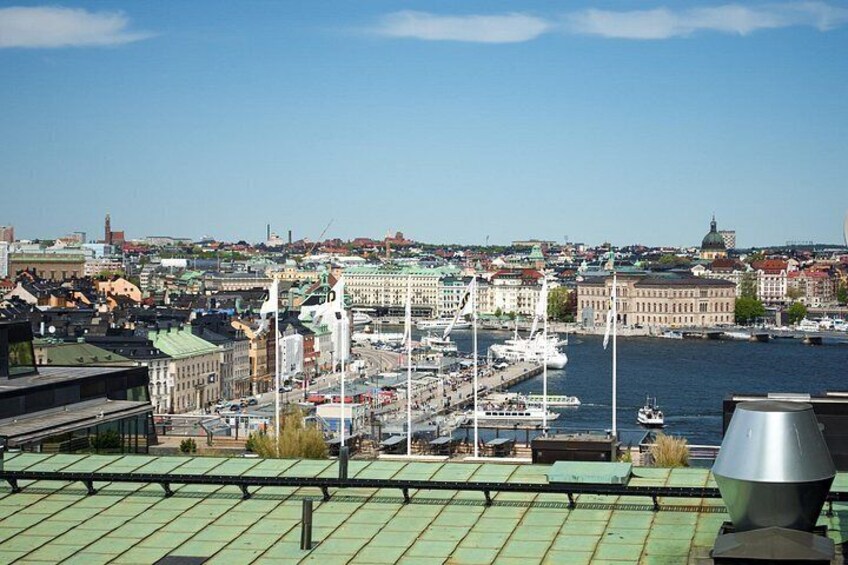 A harbor with boats, buildings, and a clear sky. 2