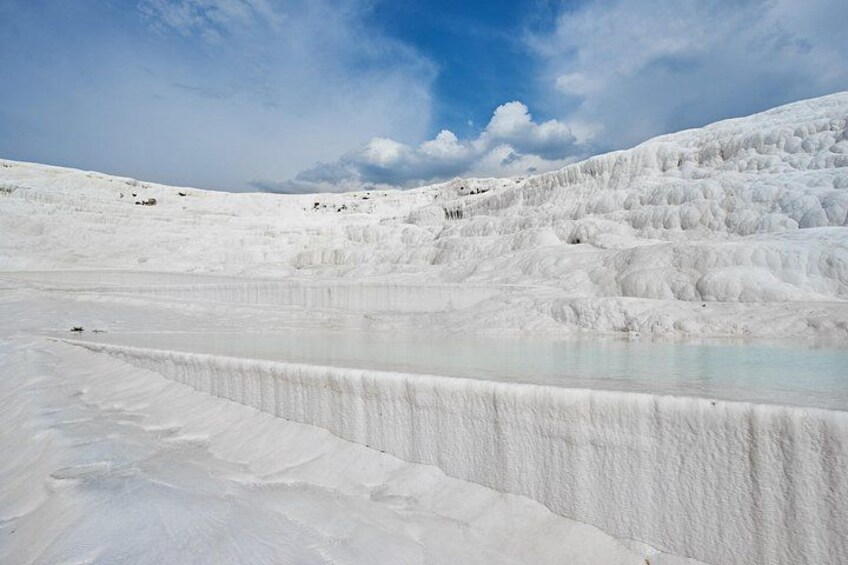 A white travertine landscape with a clear sky. 4