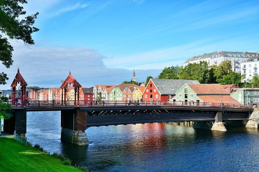 A colorful bridge over a river with buildings on the far side. 4