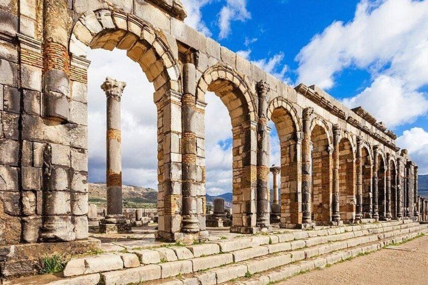Ancient stone columns and arches of a historical structure. 2