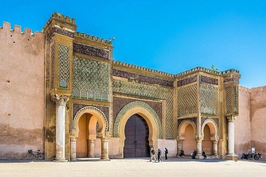 A historic gate with intricate tile work and arches. 3