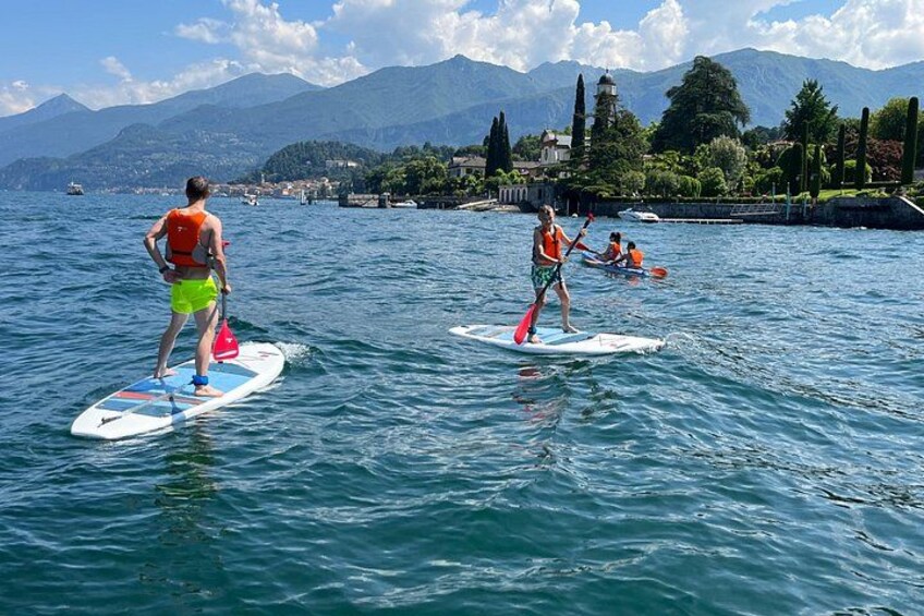 People paddleboarding on a lake with mountains in the background. 1