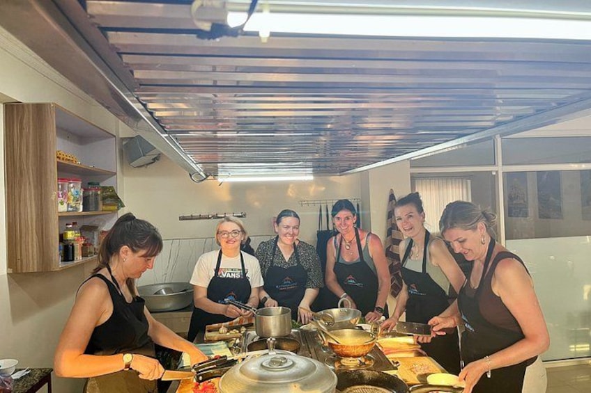 A group of people in a kitchen preparing food. 3