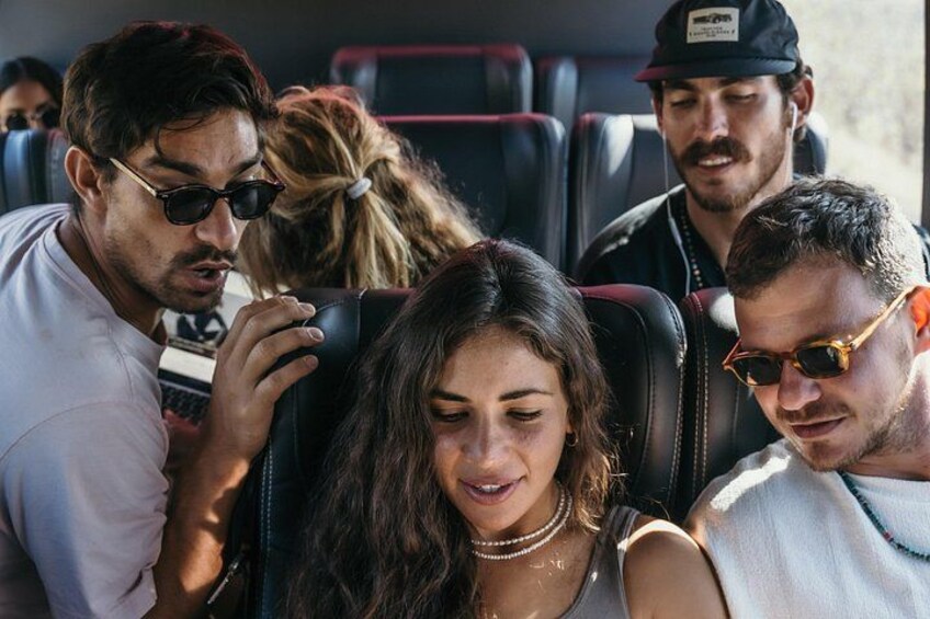 A group of people seated on a bus. 4
