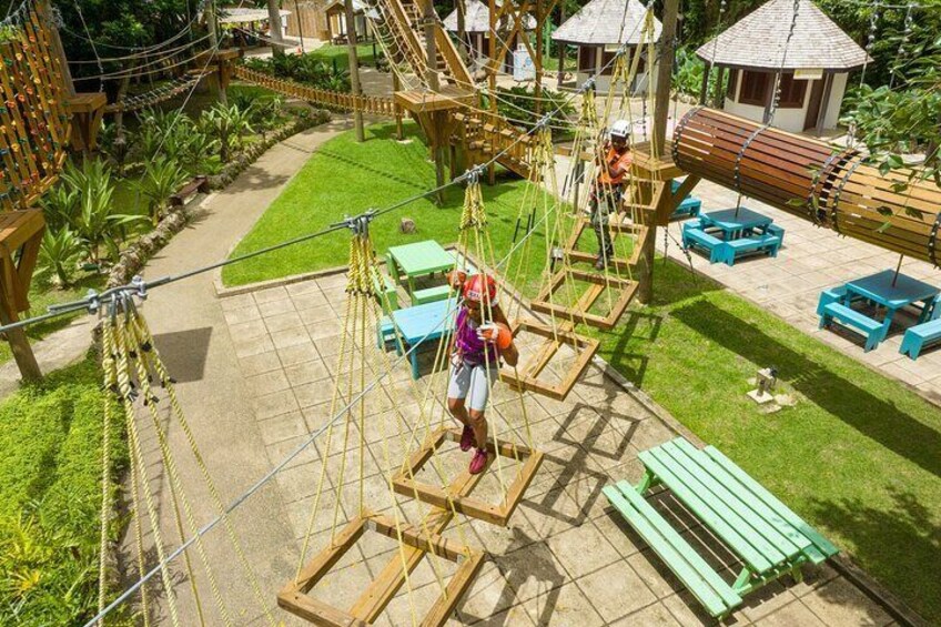 Guest climbing across the squares on the Gully Challenge Course 