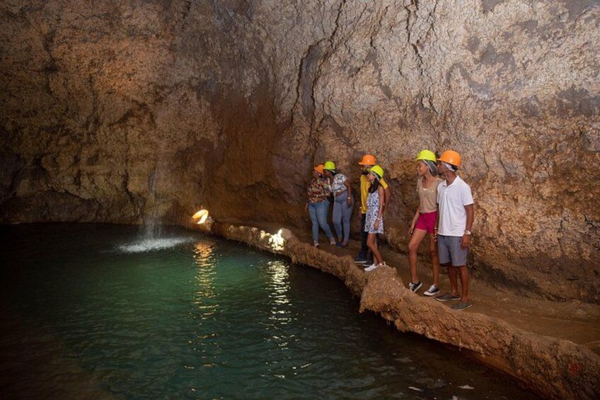 Guests at the natural waterfall inside of Harrison's Cave at the Harrison's Cave Eco-Adventure Park 4