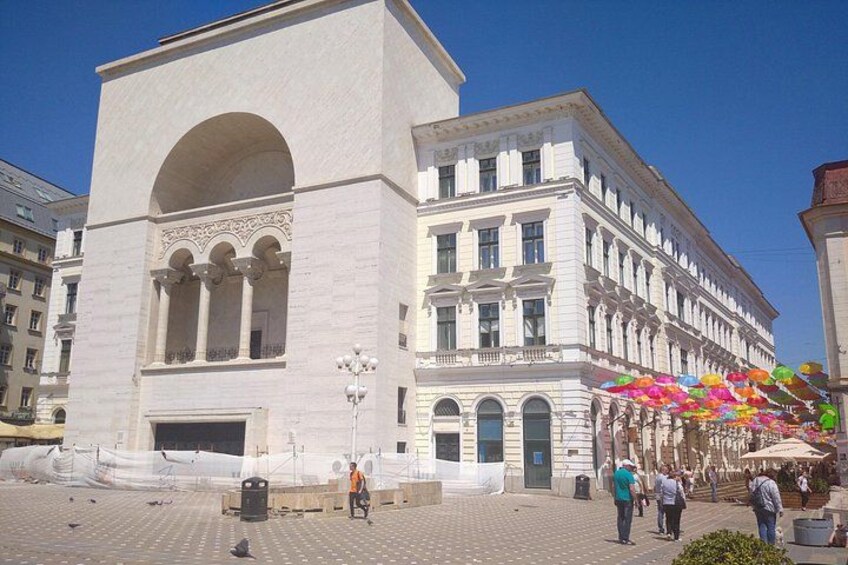A historic building with arched windows and a central entrance. 1