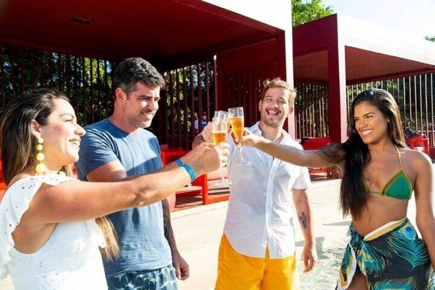 A group of people toasting with drinks at an outdoor event. 2