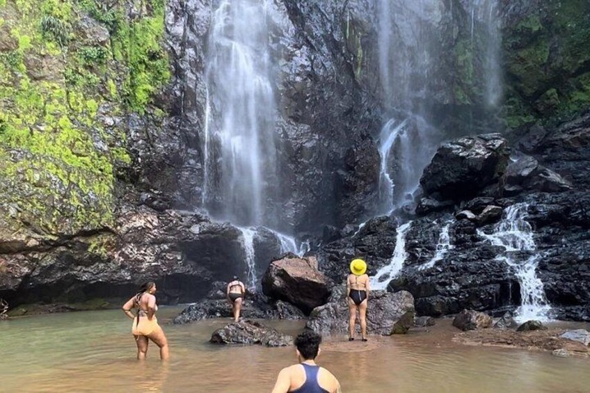 A waterfall with multiple streams, surrounded by rocks and greenery. 4