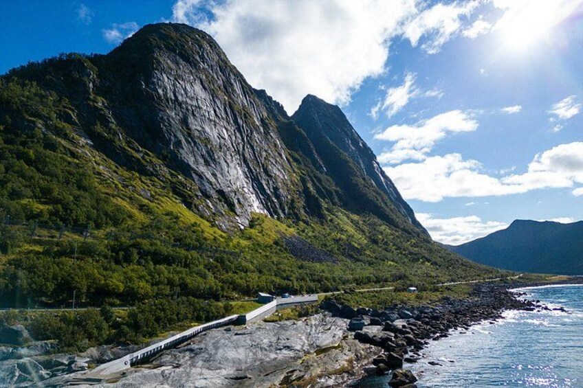 A coastal road with a mountain in the background. 2