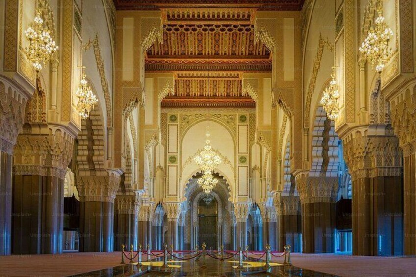 An ornate interior with intricate arches and chandeliers. 4